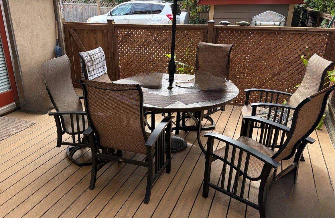 Composite deck with patio table and a lattice privacy fence